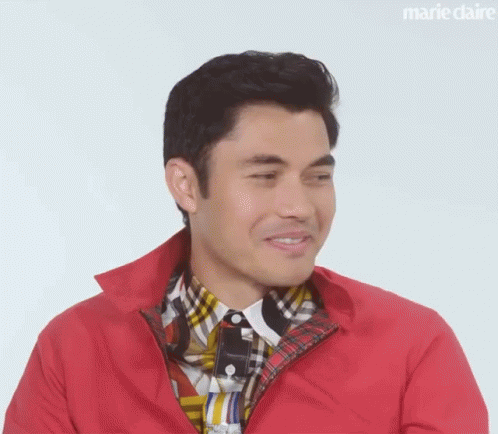 A Close Up Of A Man Wearing A Red Jacket And A Plaid Shirt . GIF