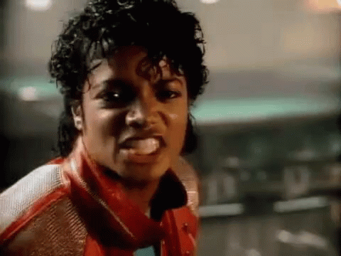 A Close Up Of A Man Wearing A Red Jacket And A Scarf Making A Funny Face . GIF