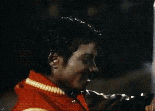 A Close Up Of A Man Wearing A Red Jacket With A Yellow Stripe GIF