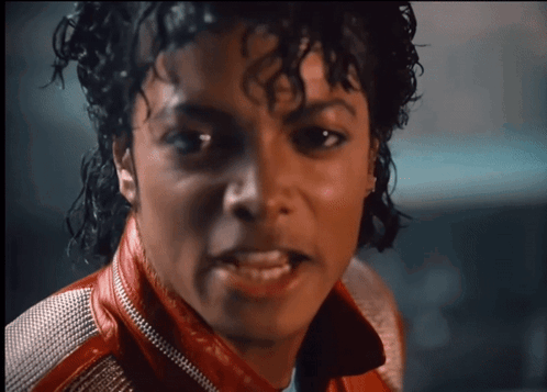 A Close Up Of A Man Wearing A Red Leather Jacket GIF