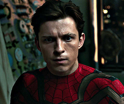 A Close Up Of A Man Wearing A Spiderman Costume GIF