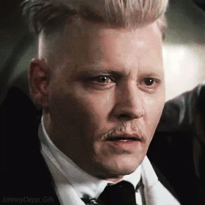 A Close Up Of A Man Wearing A Suit And Tie With A Mustache . GIF