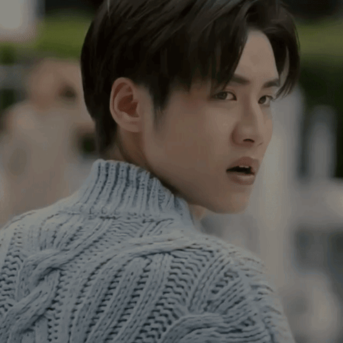 A Close Up Of A Man Wearing A Sweater With His Mouth Open GIF