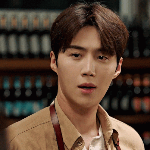 A Close Up Of A Man Wearing A Tan Shirt GIF