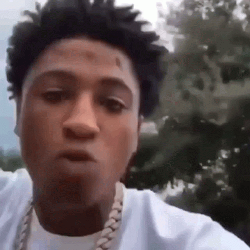 A Close Up Of A Man Wearing A White Shirt And A Gold Chain . GIF