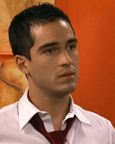 a close up of a man wearing a white shirt and red tie