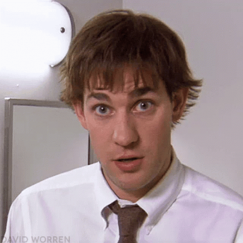 A Close Up Of A Man Wearing A White Shirt And Tie Making A Surprised Face GIF