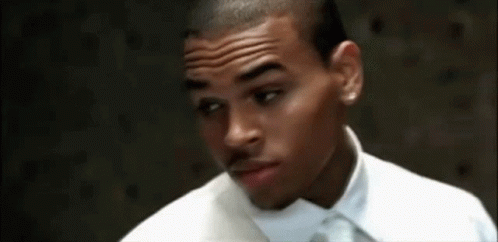 A Close Up Of A Man Wearing A White Shirt And Tie GIF