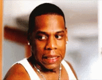 A Close Up Of A Man Wearing A White Tank Top And A Chain Around His Neck GIF