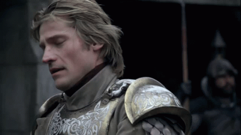 A Close Up Of A Man Wearing Armor With A Dragon On The Shoulder GIF