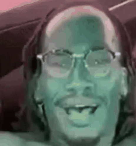 A Close Up Of A Man Wearing Glasses And A Beard . GIF