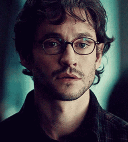 A Close Up Of A Man Wearing Glasses And A Beard GIF