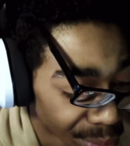 A Close Up Of A Man Wearing Glasses And A Headset GIF