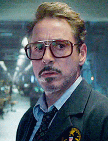 A Close Up Of A Man Wearing Glasses And A Suit And Tie . GIF