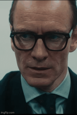 A Close Up Of A Man Wearing Glasses And A Suit With Imgflip.com At The Bottom GIF