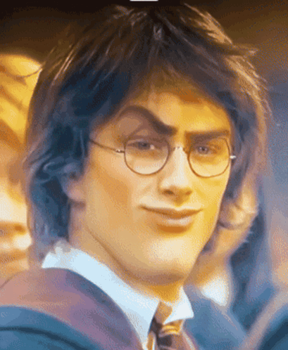 A Close Up Of A Man Wearing Glasses And A Tie Making A Funny Face GIF