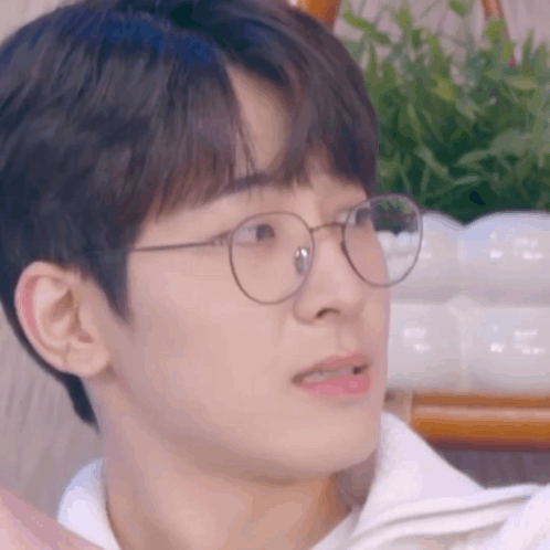A Close Up Of A Man Wearing Glasses And A White Shirt . GIF