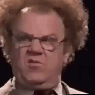 A Close Up Of A Man Wearing Glasses And A Wig . GIF