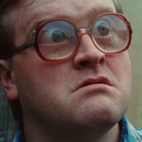 A Close Up Of A Man Wearing Glasses And Making A Funny Face GIF