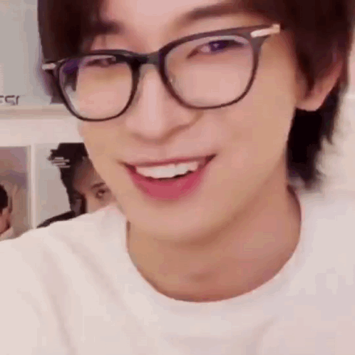 A Close Up Of A Man Wearing Glasses And Smiling . GIF
