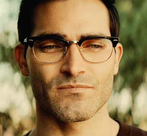 A Close Up Of A Man Wearing Glasses Looking At The Camera GIF