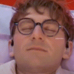 A Close Up Of A Man Wearing Glasses With His Eyes Closed . GIF