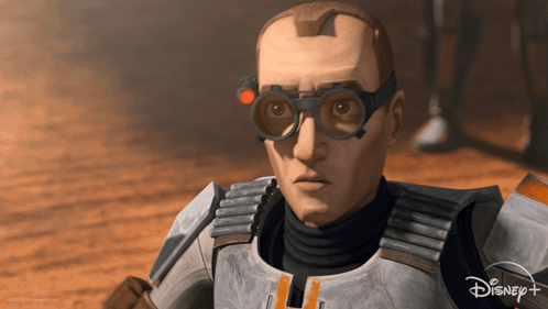 A Close Up Of A Man Wearing Goggles And A Disney + Logo GIF
