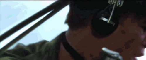 A Close Up Of A Man Wearing Headphones And A Hat With The Word Who On It GIF