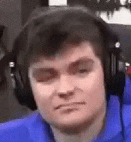A Close Up Of A Man Wearing Headphones And Making A Funny Face . GIF