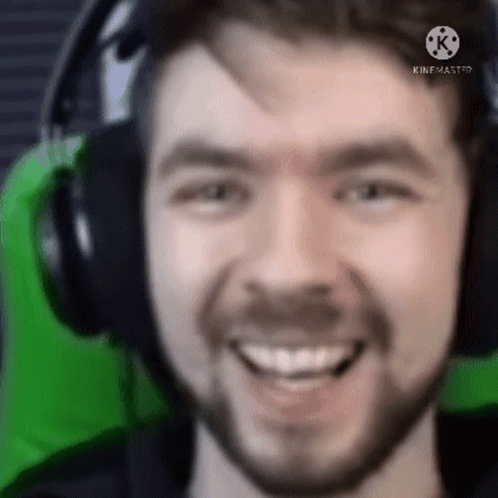 A Close Up Of A Man Wearing Headphones And Smiling GIF