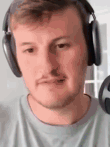 A Close Up Of A Man Wearing Headphones Making A Funny Face GIF