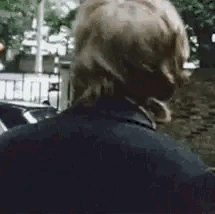 A Close Up Of A Man Wearing Headphones Standing On A Street . GIF