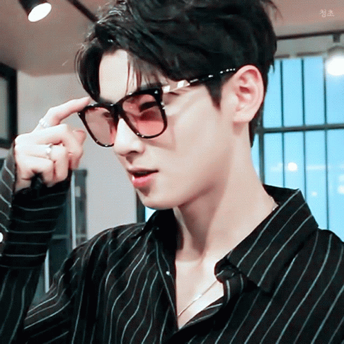 A Close Up Of A Man Wearing Sunglasses And A Black Shirt GIF