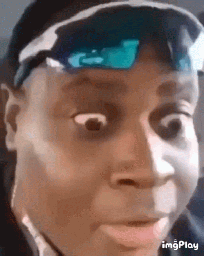 A Close Up Of A Man Wearing Sunglasses And A Hat Making A Funny Face . GIF