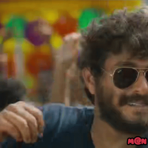 A Close Up Of A Man Wearing Sunglasses And A Mon Sticker GIF