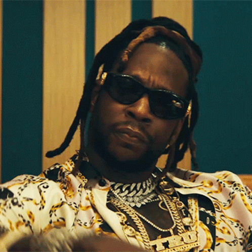A Close Up Of A Man Wearing Sunglasses And A Necklace With A Pendant That Says ' T.i. ' GIF
