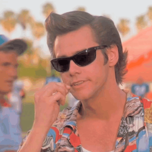 A Close Up Of A Man Wearing Sunglasses And A Shirt GIF