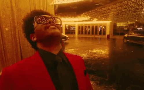 A Close Up Of A Man Wearing Sunglasses And Laughing With His Mouth Open . GIF