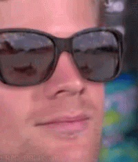 A Close Up Of A Man Wearing Sunglasses And Making A Funny Face GIF