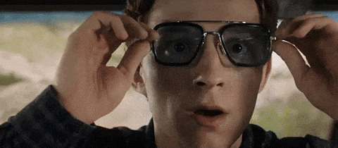 A Close Up Of A Man Wearing Sunglasses In A Car With A Surprised Look On His Face . GIF