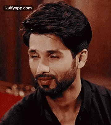 A Close Up Of A Man With A Beard And A Black Shirt . GIF