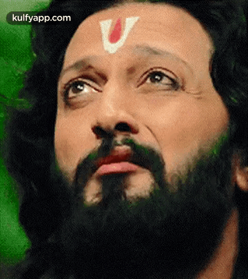 A Close Up Of A Man With A Beard And A V On His Forehead . GIF