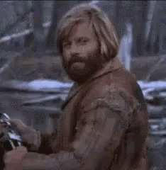 A Close Up Of A Man With A Beard And Long Hair . GIF