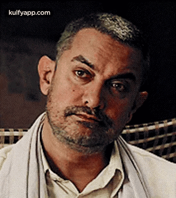 A Close Up Of A Man With A Beard And Mustache Making A Serious Face . GIF
