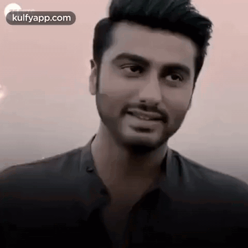 A Close Up Of A Man With A Beard And Mustache Smiling . GIF