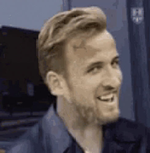 A Close Up Of A Man With A Beard Smiling And Looking To The Side . GIF