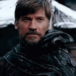 a close up of a man with a beard wearing a black coat