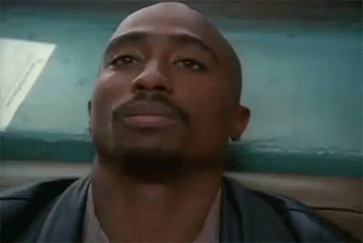 A Close Up Of A Man With A Beard Wearing A Leather Jacket And A White Shirt . GIF