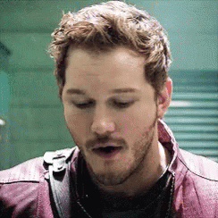 A Close Up Of A Man With A Beard Wearing A Purple Jacket . GIF