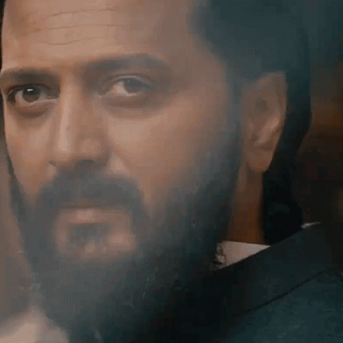 A Close Up Of A Man With A Beard Wearing A Suit And Tie GIF